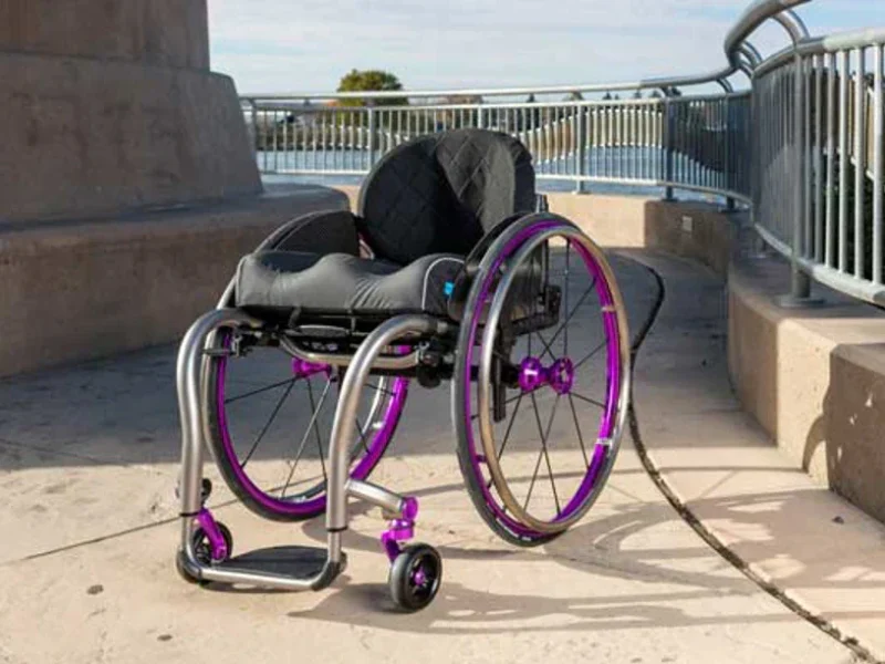 A purple and silver tilite wheelchair with specialist seating